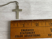 Load image into Gallery viewer, antique silver cross shown width-wise next to a wooden ruler to show the width as about .75 inches