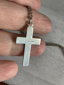 the back of the cross pendant, showing the vintage mark certifying it as sterling silver